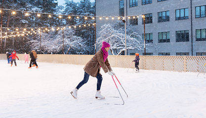 Image showing happy woman at outdoor skating rink in winter