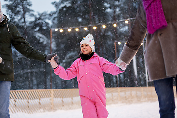 Image showing happy family at outdoor skating rink in winter