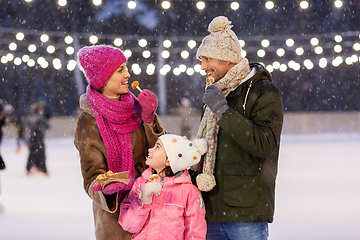 Image showing happy family eating pancakes on skating rink