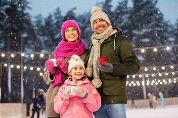 Image showing happy family drinking hot tea on skating rink