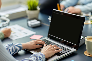 Image showing businesswoman with laptop working at office