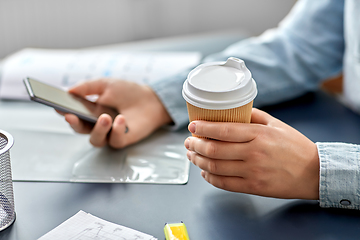 Image showing woman with coffee using smartphone at office