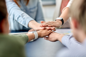 Image showing close up of business team stacking hands