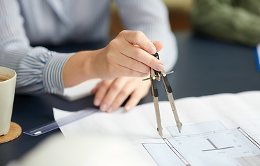 Image showing architect with blueprint and drafting compass