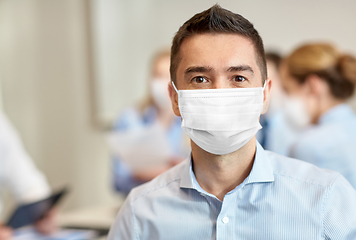 Image showing businessman wearing face protective mask at office