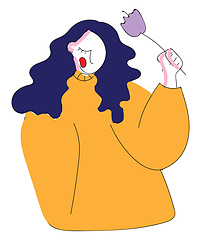 Image showing Girl with blue hair and light orange sweater holding purple flow