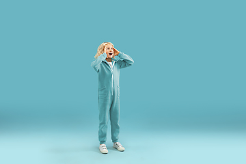 Image showing Childhood and dream about big and famous future. Pretty curly boy isolated on blue background