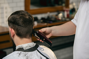 Image showing Close up of client of master barber, stylist during getting care