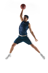 Image showing Young arabian basketball player of team in action, motion isolated on white background. Concept of sport, movement, energy and dynamic.