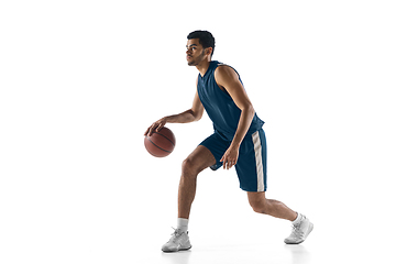 Image showing Young arabian basketball player of team in action, motion isolated on white background. Concept of sport, movement, energy and dynamic.