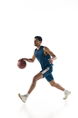 Image showing Young arabian basketball player of team in action, motion isolated on white background. Concept of sport, movement, energy and dynamic.