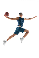 Image showing Young arabian basketball player of team in action, motion isolated on white background. Concept of sport, movement, energy and dynamic.