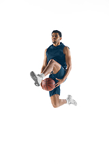 Image showing Young arabian basketball player of team in action, motion isolated on white background. Concept of sport, movement, energy and dynamic.