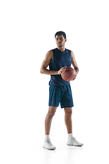 Image showing Young arabian basketball player of team posing isolated on white background. Concept of sport, movement, energy and dynamic.