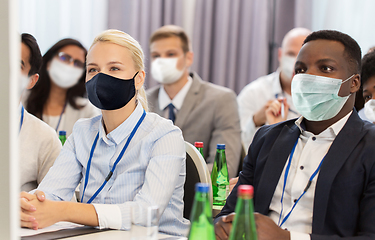 Image showing business people in masks at worldwide conference