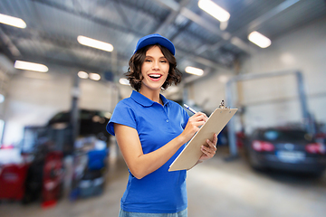 Image showing female worker with clipboard at car service