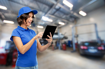 Image showing happy female worker with tablet pc at car service