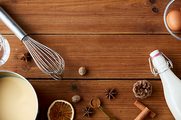 Image showing pot with eggnog, ingredients and spices on wood