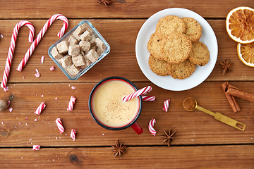 Image showing cup of eggnog with candy cane, cookies and sugar