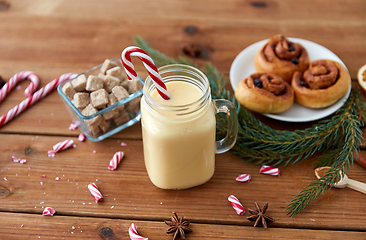 Image showing eggnog with candy cane in mug and cinnamon buns