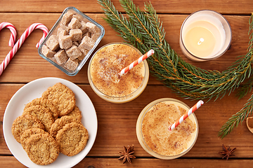 Image showing glasses of eggnog, oatmeal cookies and fir branch