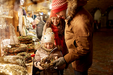 Image showing happy family buing wreath at christmas market