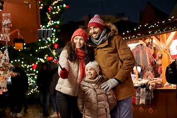 Image showing happy family taking selfie at christmas market
