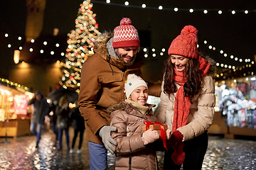 Image showing happy family with gift at christmas market in city