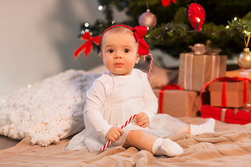 Image showing baby girl at christmas tree with gifts at home