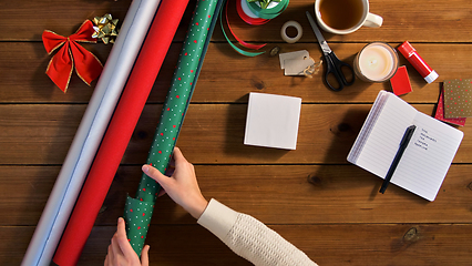 Image showing hands setting stuff for christmas gifts wrapping