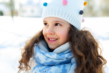 Image showing happy little girl in winter clothes outdoors