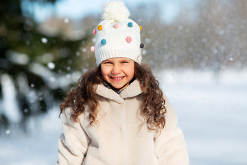 Image showing happy little girl in winter clothes outdoors