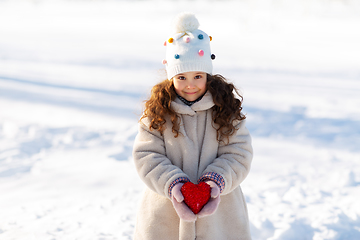 Image showing happy little girl with heart outdoors in winter