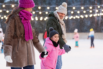 Image showing happy family at outdoor skating rink in winter