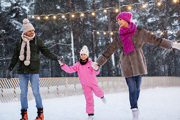 Image showing happy family at outdoor skating rink in winter