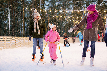 Image showing happy family at outdoor skating rink in winter