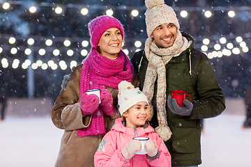 Image showing happy family drinking hot tea on skating rink