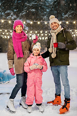 Image showing happy family drinking hot tea on skating rink