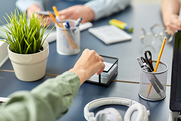 Image showing businesswoman taking note paper at office