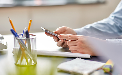 Image showing close up of woman with using smartphone at office