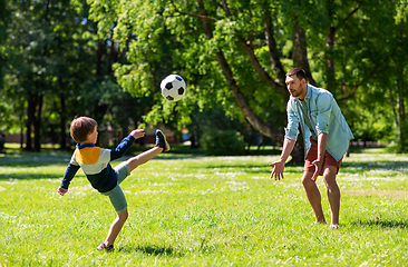 Image showing father with little son playing soccer at park