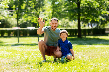 Image showing happy smiling father and little son at summer park