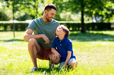 Image showing happy father and son talking at summer park