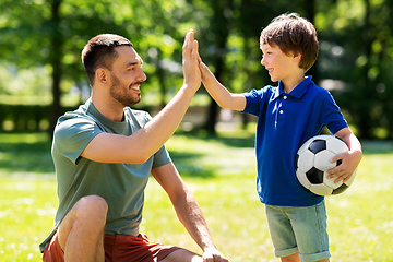 Image showing father giving five to son with soccer ball at park