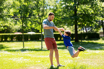 Image showing happy father with son playing in summer park