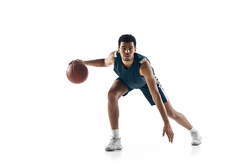 Image showing Young arabian basketball player of team in action, motion isolated on white background. Concept of sport, movement, energy and dynamic.