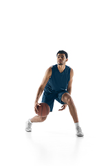 Image showing Young arabian basketball player of team in action, motion isolated on white background. Concept of sport, movement, energy and dynamic.