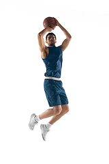 Image showing Young arabian basketball player of team in action, motion isolated on white background. Concept of sport, movement, energy and dynamic.