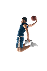 Image showing Young arabian basketball player of team in action, motion isolated on white background. Concept of sport, movement, energy and dynamic.