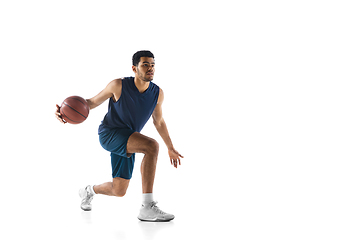 Image showing Young arabian basketball player of team in action, motion isolated on white background. Concept of sport, movement, energy and dynamic.